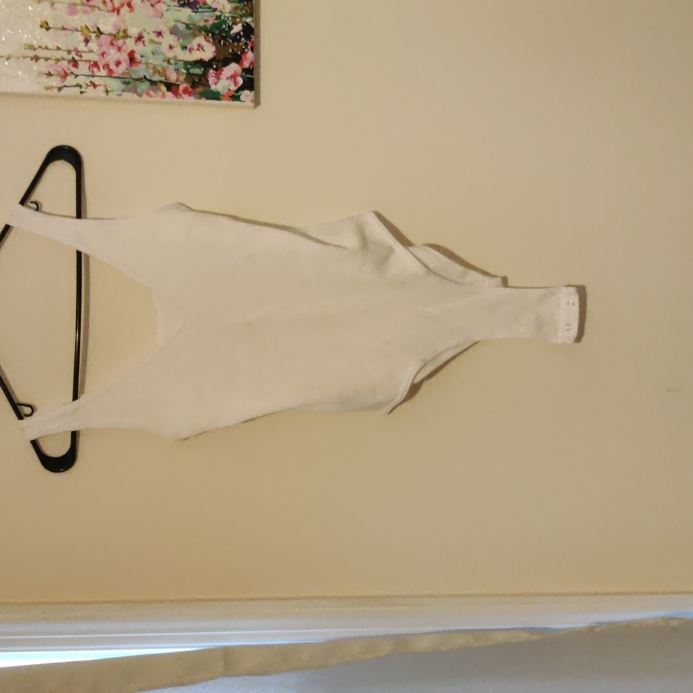 A white bodysuit. The brand is on noon